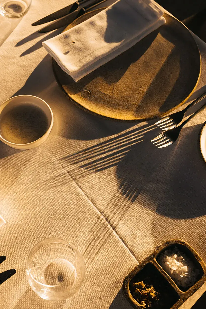 Table set with ceramic plates in evening light
