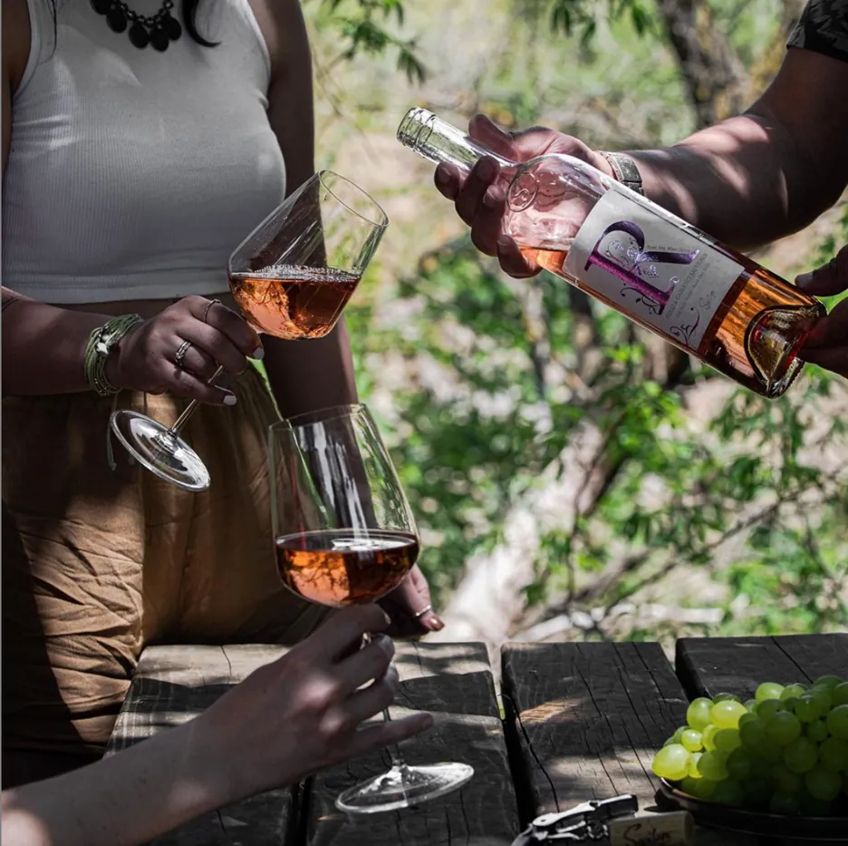 Rosé wine being poured at an outdoor table